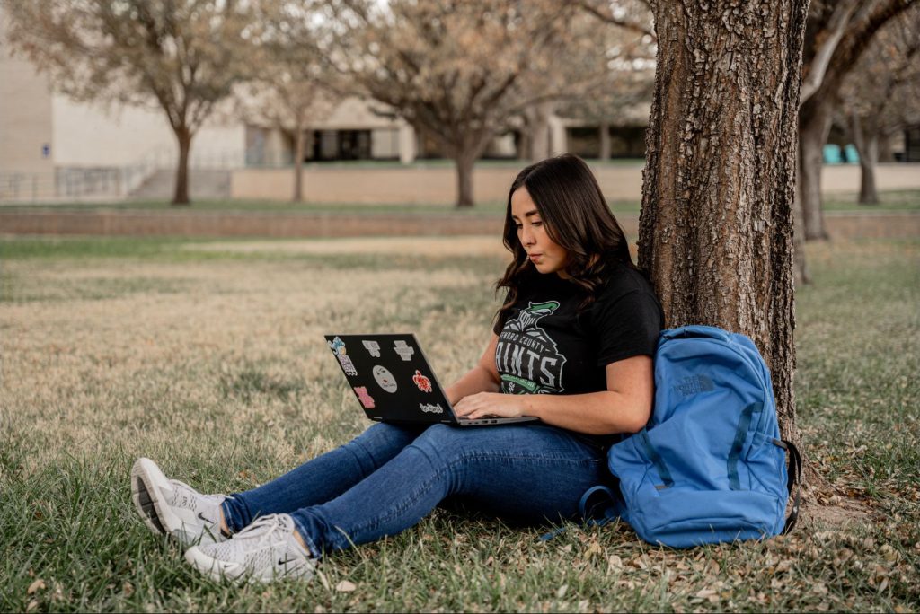 Student studying online in court yard